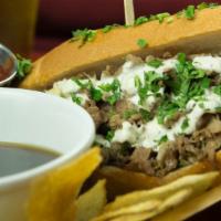 Prime Rib French Dip · Thinly sliced prime rib sandwich topped with Swiss cheese & creamy horseradish. Served on Du...