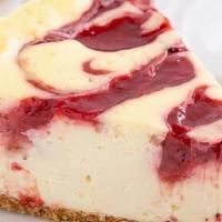 Strawberry Swirl Cheesecake Slice (New!!!)  · Cheesecake slice with strawberry swirl on top with whip cream.