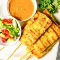 Chicken Sa–Tay · Grilled marinated chicken breast on skewer, served with peanut sauce and cucumber salad.