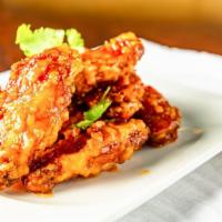 Thai Wings · Fresh marinated chicken wings, deep-fried and tossed in tamarind spicy sauce.