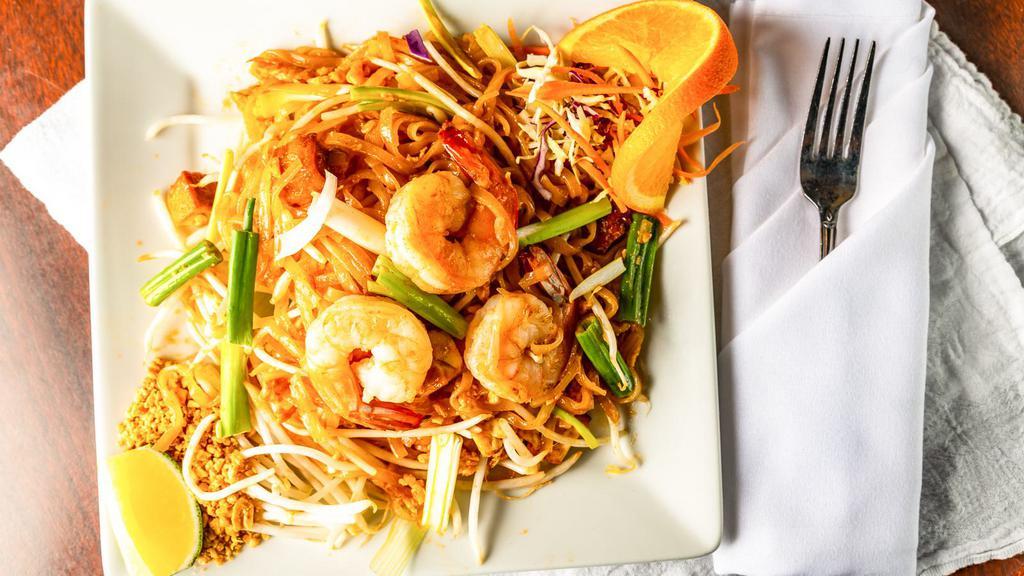 Pad Thai · Pan-fried rice noodles with choice of meat,  egg, bean sprouts and green onions topped with ground peanut.