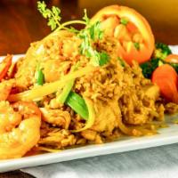 Pineapple Fried Rice · Wok- fried rice with chicken, prawns, egg, pineapple, onion, cashew nuts, and curry powder.