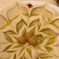 Hummus · Mashed chickpeas (garbanzo beans) blended with tahini, olive oil, lemon juice, salt and garl...