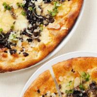 Mushroom Truffle Pizza · Three cheese, sautéed mushrooms, truffle oil, basil.