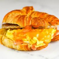 Croissant Sausage, Egg & Cheddar Sandwich · 2 fresh cracked cage-free scrambled eggs, melted Cheddar cheese, breakfast sausage, and Srir...