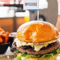 The Impossible™ Burger · Delicious plant-based burger, arugula, tomato jam, peppered mushrooms, truffle aioli, parmes...