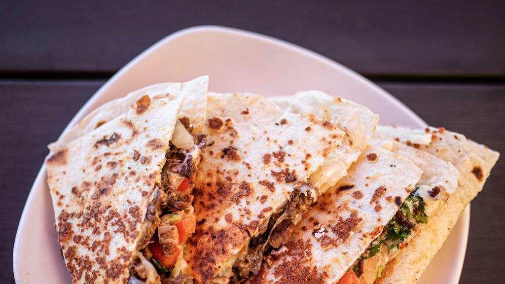 Chando'S Quesadilla · Select your favorite of chando's signature meat (1 Selection) and enjoy it sandwiched between a giant flour tortilla that is grilled to perfection with creamy melted jack cheese and topped with pico-de-gallo, guacamole, sour cream, and salsa.