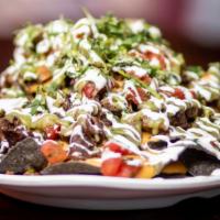 Chando'S Nachos · House made chips, your choice of chando's signature meats (1 Selection), nacho cheese, cilan...
