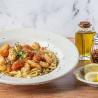 Shrimp Scampi · Shrimp, cherry tomato, onions sautéed with garlic, lemon, and white wine sauce served over l...