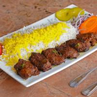 Shish Kabob · Chunks of skewered marinated filet mignon served with broiled tomato, vegetables and basmati...