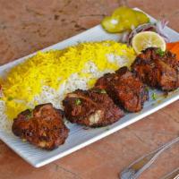 Lamb Loin Chops · Skewered marinated lamb chops served with broiled tomato, vegetables and basmati rice with s...