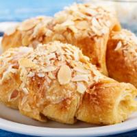 Almond Croissant · Buttery, flaky croissant filled with almonds.