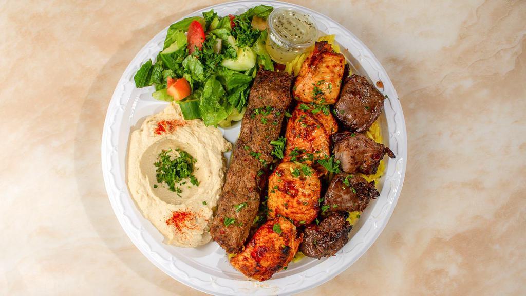 Mix Grill Plate · A combination for meat lovers, This plate includes Three pieces of chicken kabab, Three pieces of beef kabab, and a Skewer of beef lula (Ground beef), the beef kabab can be substituted by lamb kabab for an extra charge