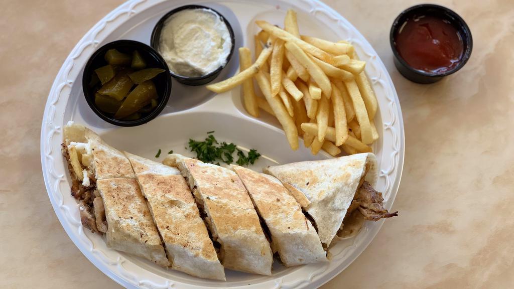 Pita Grill Shawarma- Chicken · Our Chicken Shawarma wrapped in a flat bread and toasted before cut in pieces, served with fries, garlic, and pickles