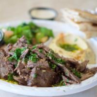 Tri - Tip Shawarma Plate · Marinated strips of tri-tip flame-broiled and served with a side of tahini sauce.