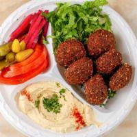 Falafel Plate · Six pieces of fresh hot crispy falafels served with salad, hummus, pickles and tahini.