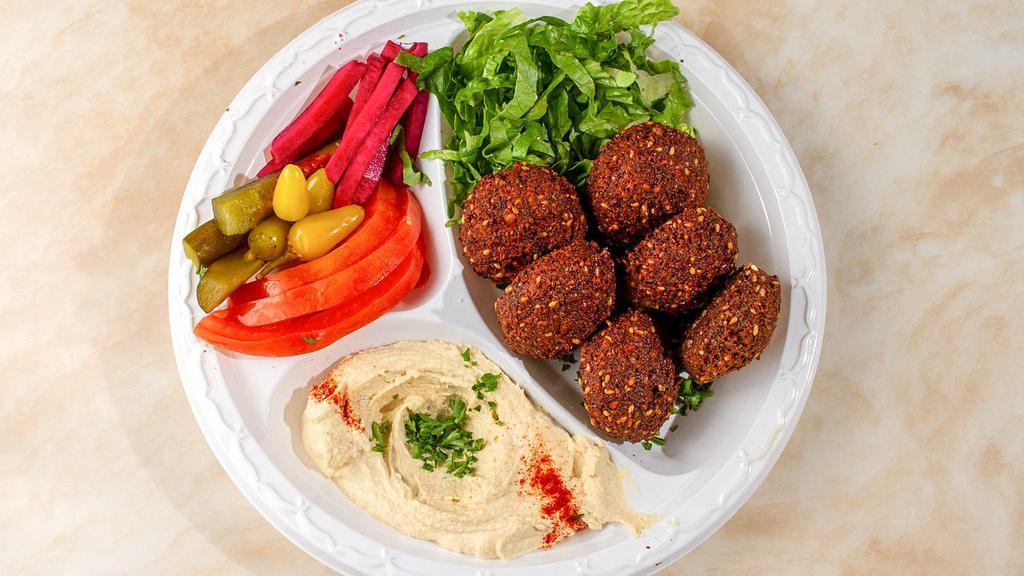 Falafel Plate · Six pieces of fresh hot crispy falafels served with salad, hummus, pickles and tahini.
