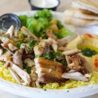 Half Chicken Shawarma Plate · Chicken strips sliced off the broiler served with salad, hummus, rice, and pita bread.