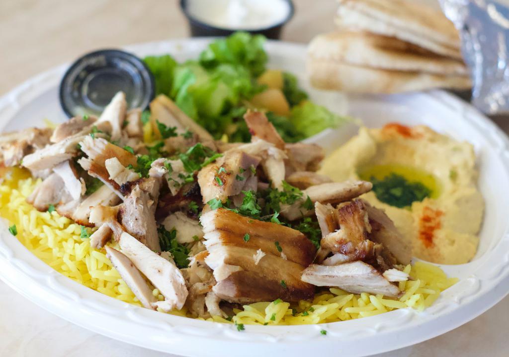 Half Chicken Shawarma Plate · Chicken strips sliced off the broiler served with salad, hummus, rice, and pita bread.