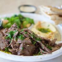 Half Tri - Tip Shawarma Plate · Tri-tip strips sliced off the broiler served with salad, hummus, rice, and pita bread.