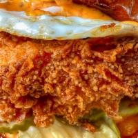 The Country Fried Chicken · buttermilk chicken breast, calabrian chili spread, over medium egg, county fair dill pickles...