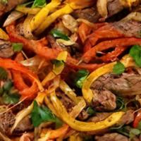 Fajitas - Steak Or Chicken · Marinated chicken or steak grilled with onions, bell peppers and tomato served with rice, be...