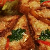 Fish Cakes · served with cucumber and peanut sauce.