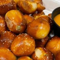 Jalapeno Pretzel Bites · Bite-size pretzels baked with grain from our brewhouse. Made with jalapenos & served with Si...