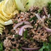 Larb · Grounded chicken or pork, green onion, red onion, cilantro and rice powder  mixed with fresh...