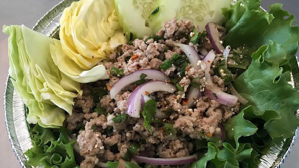 Larb · Grounded chicken or pork, green onion, red onion, cilantro and rice powder  mixed with fresh lime dressing