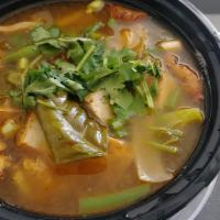 Tom Yum (Hot & Sour Soup) · Mushroom, onion, cilantro, lemongrass, kaffir leaves, tomatoes, onion, and galangal in the l...
