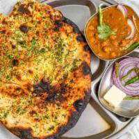 Amritsari Kulcha · Stuffed naan with potatoes, onion, and coriander, well seasoned with a side of channa masala.