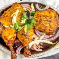 Tandoori Chicken · Chicken marinated in yogurt, garlic, ginger, spices and BBQ in a clay oven.