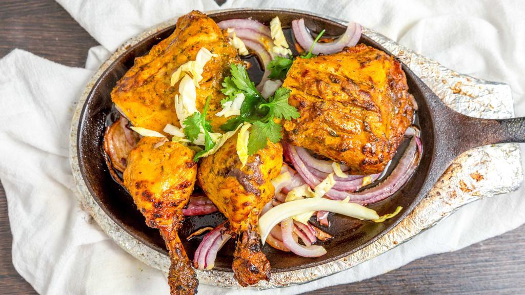 Tandoori Chicken · Chicken marinated in yogurt, garlic, ginger, spices and BBQ in a clay oven.