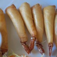 Golden Prawns · Prawns wrapped in wonton skin then deep-fried served with sweet and sour sauce.