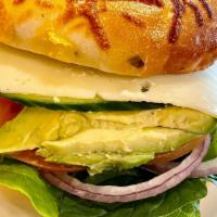 Veggie Bagel · Sun-dried tomato mayo spread, romaine, red onion, avocado, spinach, tomatoes, cucumber, spro...