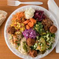 Combo Salad Plate · Served with all of our mediterranean salads (14), crispy falafel balls (4), a freshly-baked ...