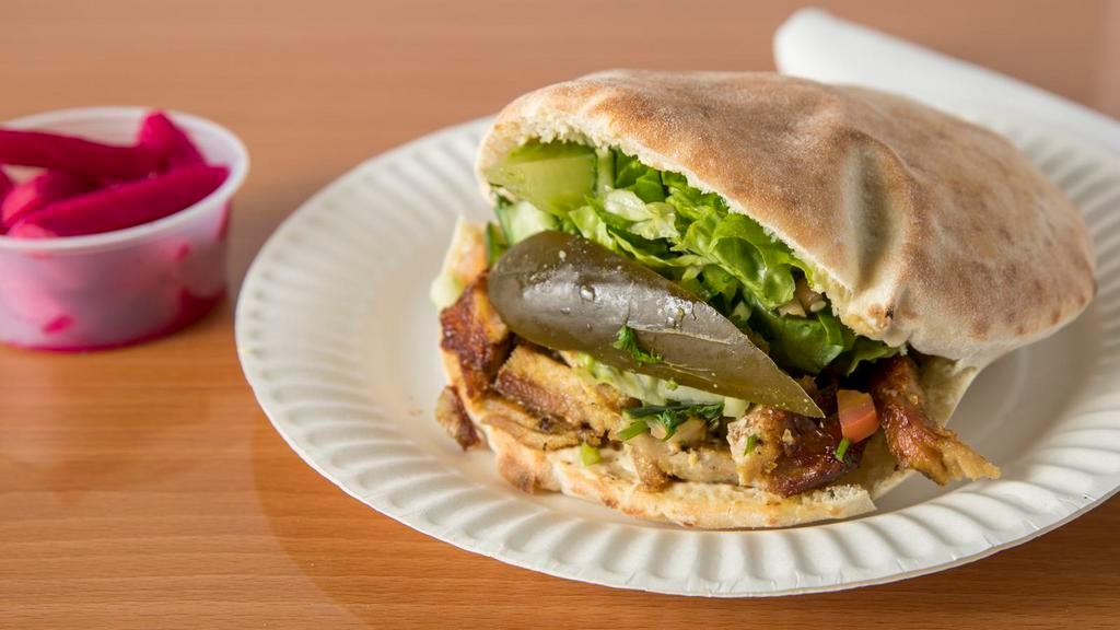 Shawarma Sandwich · Prepared in a freshly-baked pita bread, filled with shawarma (chicken, lamb & turkey, or mixed), hummus, chopped lettuce, israeli salad (cucumbers & tomatoes), pickles, and your choice of sauces.