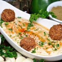 Hummus & Tahina · A side of creamy hummus and rich tahina, peppered with paprika, cumin, olive oil, and parsle...