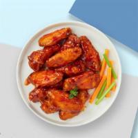 Baffling Buffalo Chicken Wings · Fresh chicken wings breaded, fried until golden brown, and tossed in buffalo sauce. Served w...