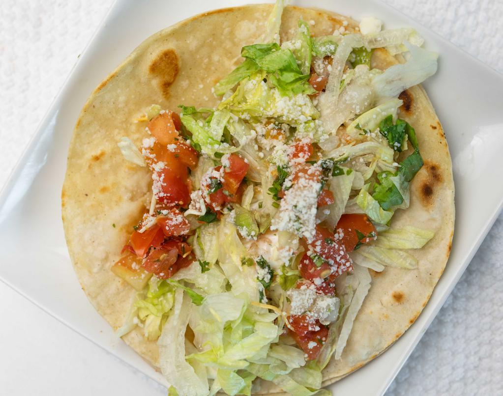 Fish Taco · Double Corn Tortilla filled with grilled Tilapia  Fish, Tarter Sauce Lettuce, Pico de Gallo, and  Grated Cotija Cheese