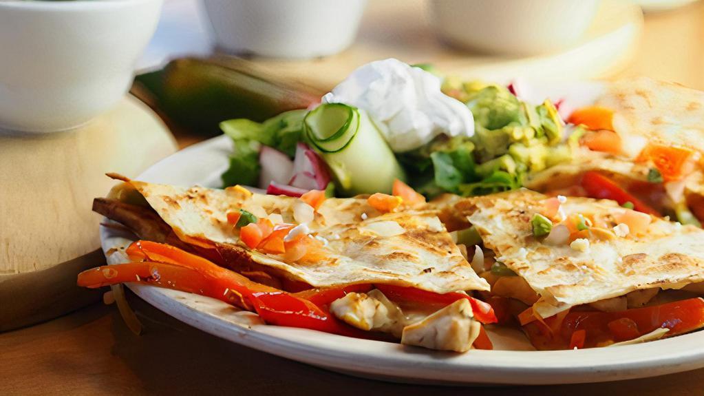 Quesadilla De Fajitas · Our delicious chicken or steak fajitas in a soft flour tortilla with melted Jack and Cheddar cheese.