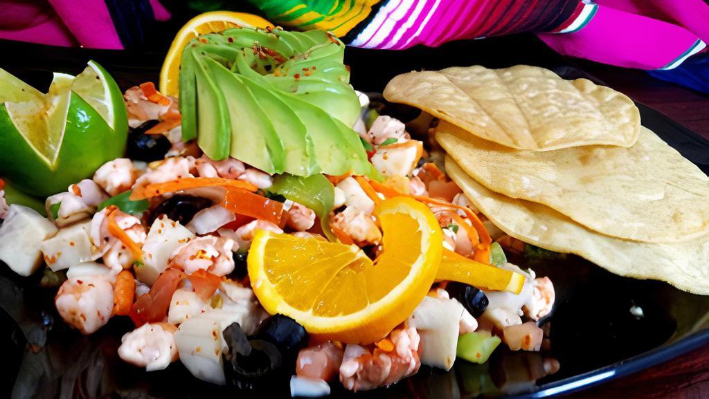 Ceviche Azteca · Tilapia and shrimp marinated in freshly squeezed lime juice, gently mixed with diced onions, 
tomatoes, carrots, olives, cilantro, and mild green chilies. Served chilled with tostadas.