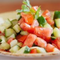 Shirazi Salad · Chopped cucumbers, tomatoes and our house vinaigrette dressing. Vegetarian. Gluten-free.