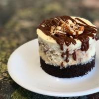 German Chocolate Cheesecake · Our traditional cheesecake swirled with coconut pecan filling and chocolate ganache, on an o...