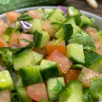Persian Salad · Diced tomatoes, onion, cucumber, parsley, and mint mixed with olive oil and lemon juice.