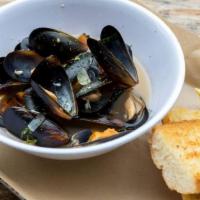 Drunken Mussels · Black Mussels in our zesty tomato basil white wine broth served with grilled garlic bread