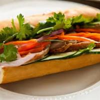 Pork Bahn Mi · Pork belly served on a french baguette with carrots, daikon, cucumber, and mint.