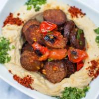 Soujoukh With Hummus · Gluten-free. Hummus topped with sautéed beef sausage and diced tomato.
