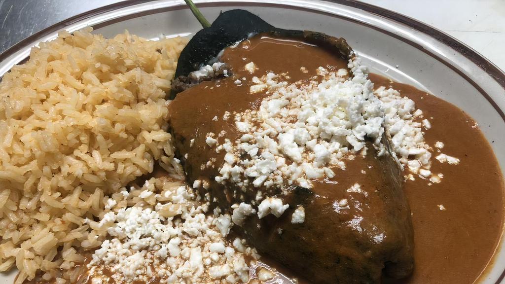 Chile Relleno · Poblano pepper stuffed with panela or Oaxaca cheese served with beans, rice.